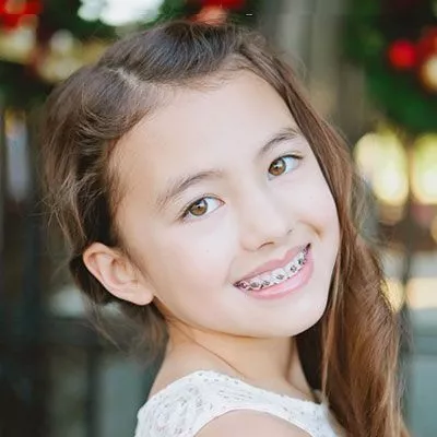 Portrait of girl smiling with braces | Frisco's Premier Orthodontics