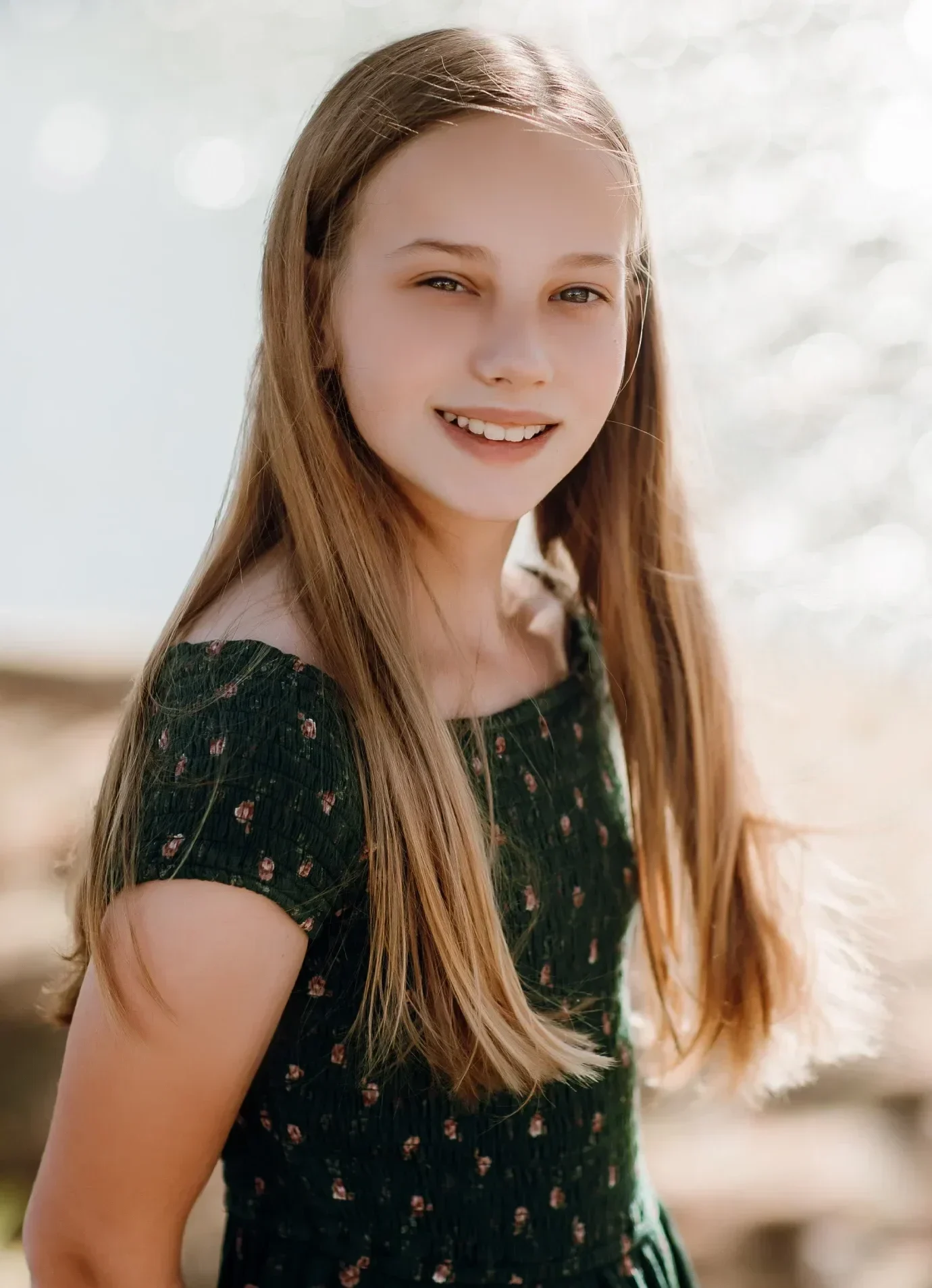 Blonde young girl with Invisalign® smiling for photo | Frisco's Premier Orthodontics