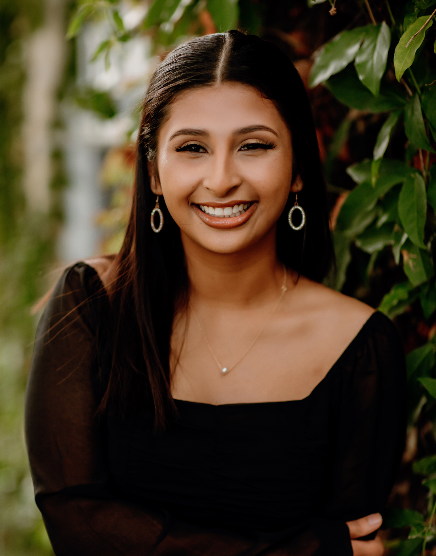 Smiling dark-haired woman posing for photo | Frisco's Premier Orthodontics